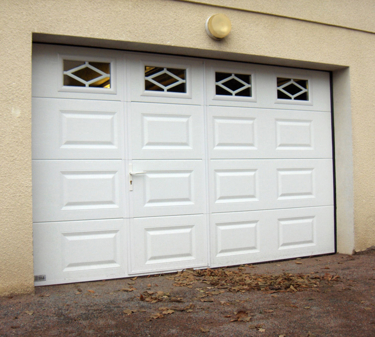 Habitat cassette portillon avec porte de garage sectionnelle blanche en pvc et quatre fenêtres ajourées pour les particuliers.